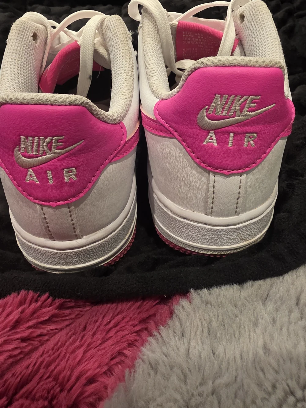 Nike Air Force 1 White Low-Top with Bright Pink Swoosh and Outsole.